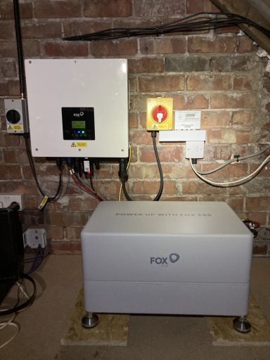 Control panel and equipment mounted on a brick wall in a basement setting.